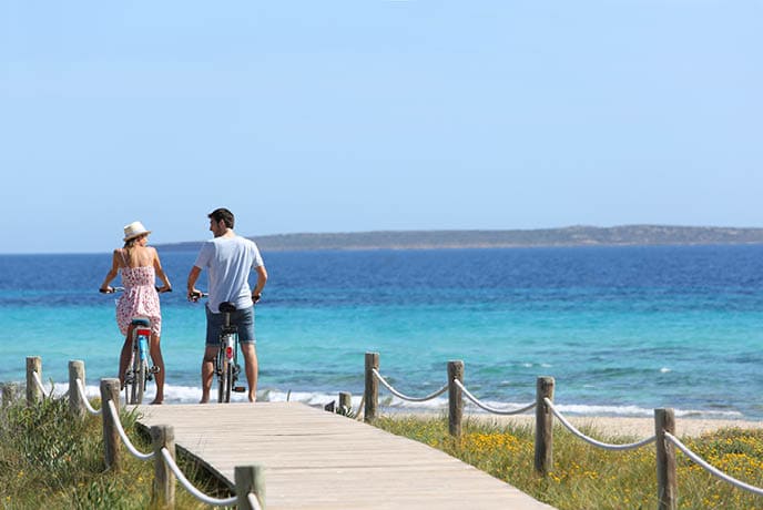 Couple riding bikes on Formentera Island