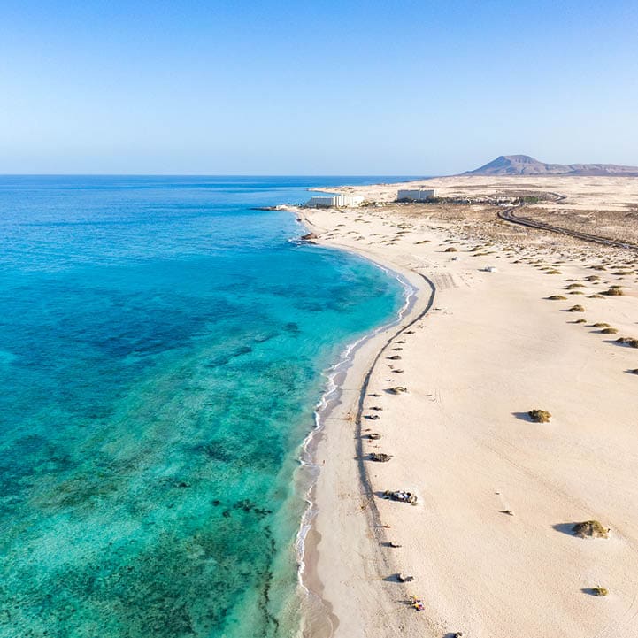 Panoramic high angle aerial drone view of Corralejo National Park (Parque Natural de Corralejo) with sand dunes located in the northeast corner of the island of Fuerteventura, Canary Islands, Spain.