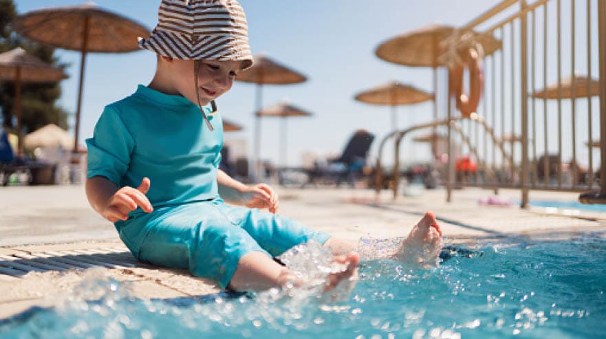 Toddler boy enjoying a day at the swimming pool.