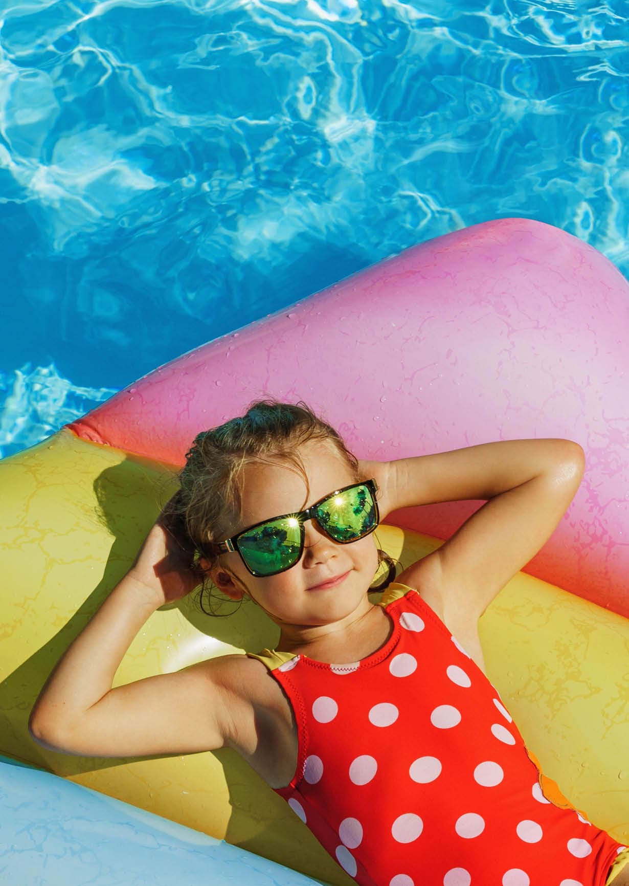 Child in swimming pool. Having fun on vacation at the hotel pool. Colorful vacation concept.; Shutterstock ID 2140684337; purchase_order: -; job: -; client: -; other: -