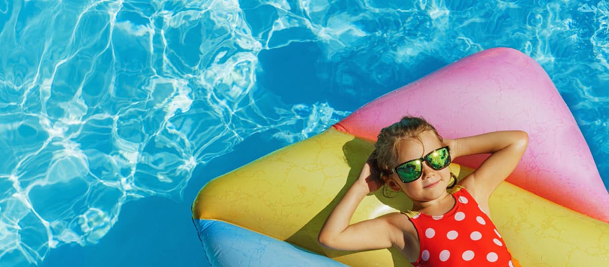Child in swimming pool. Having fun on vacation at the hotel pool. Colorful vacation concept.; Shutterstock ID 2140684337; purchase_order: -; job: -; client: -; other: -