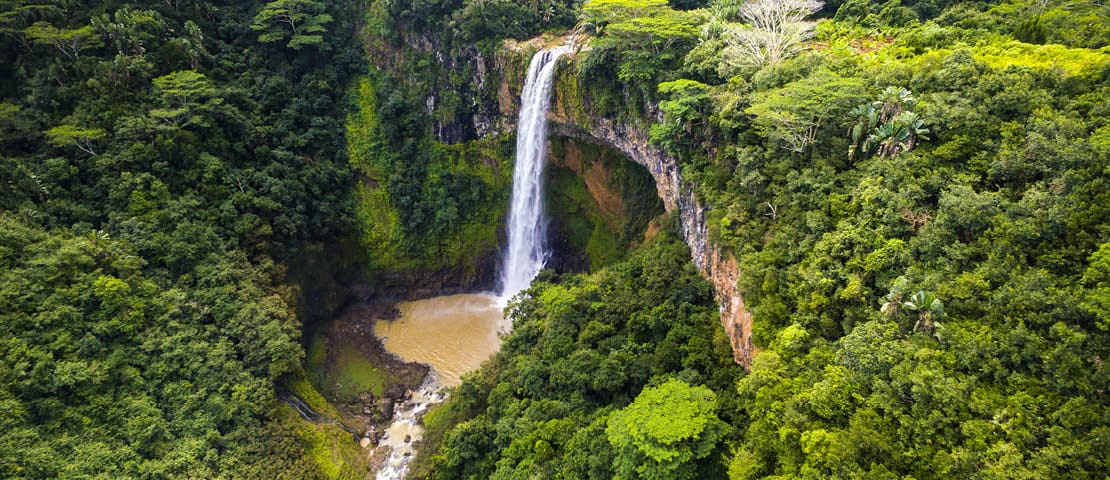 Aerial top view perspective of Chamarel Waterfall in the tropical island jungle of Mauritius
