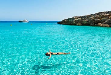 Idyllic holidays: girl floating in fresh clean turquoise water.